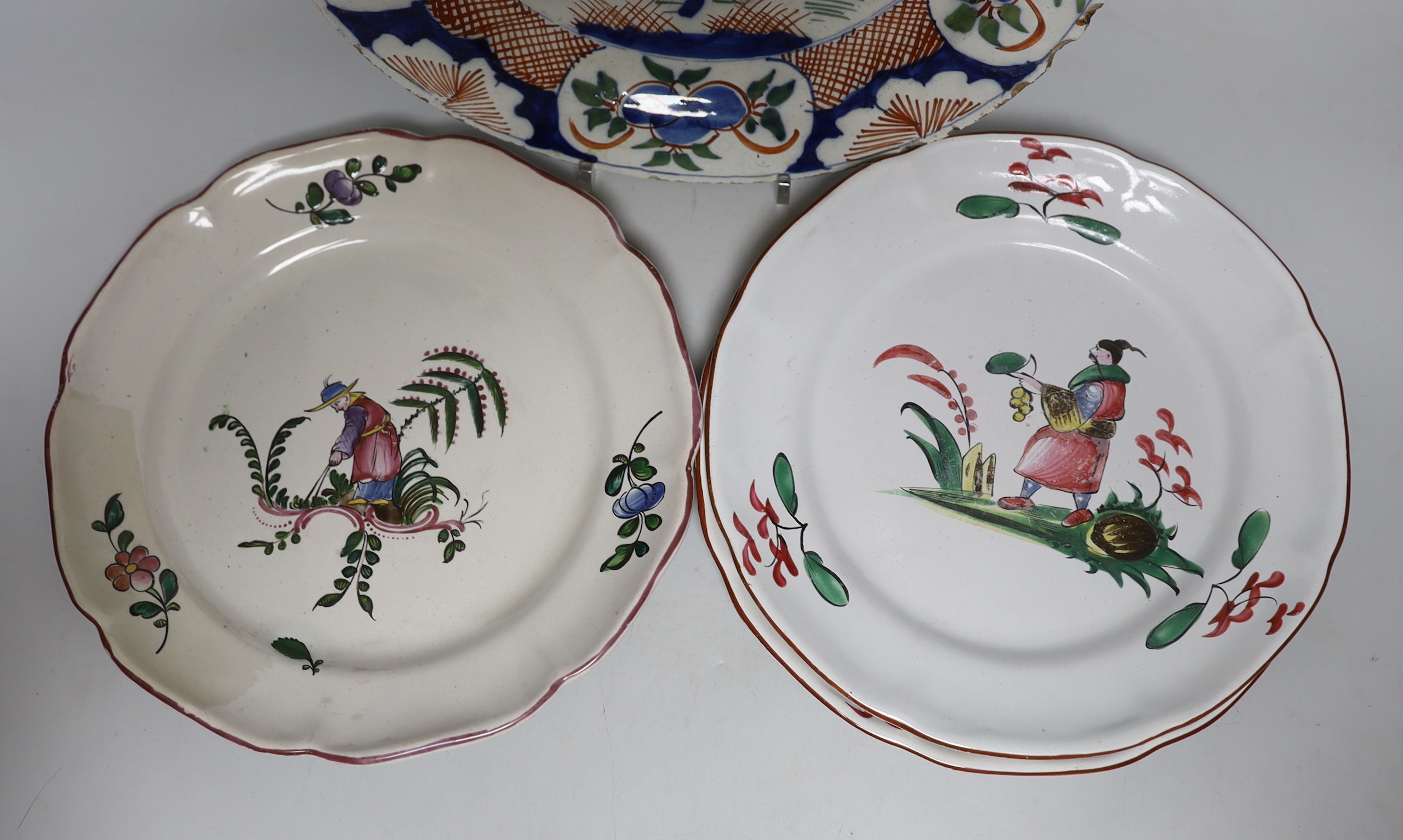 An 18th century Delft plate and three 19th century faience plates, largest 26cm diameter (4)